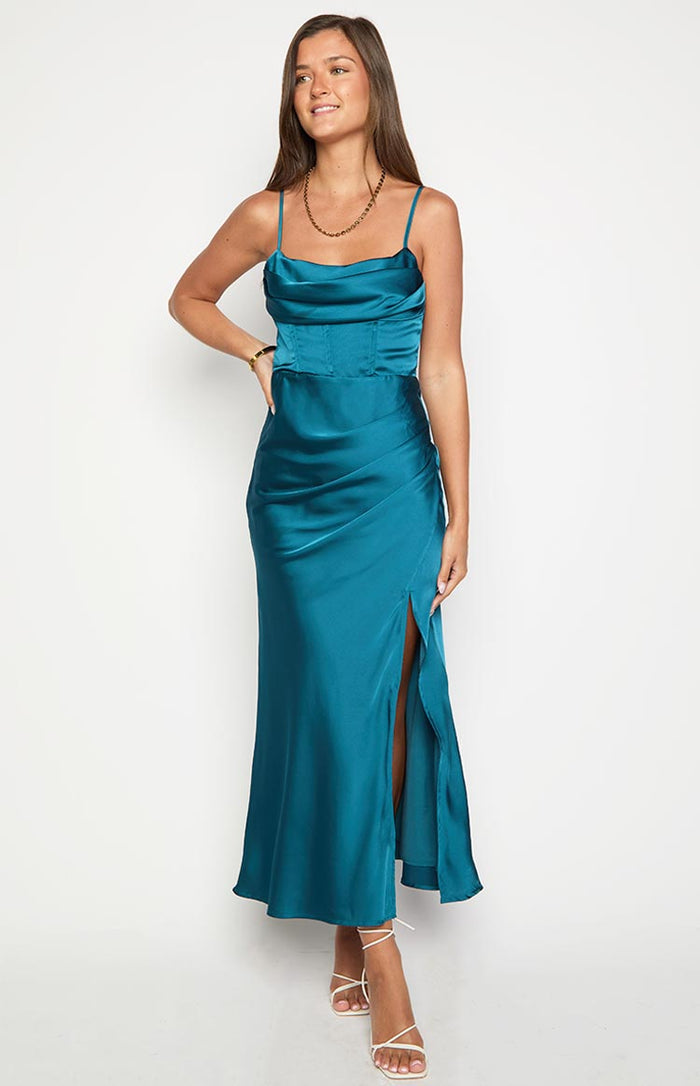 Green satin maxi dress with a cowl neck, thin straps, corset-style bodice, ruched hip detail, and a high thigh split