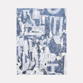 The artwork "Grey Convo 2" features an abstract collage of distressed textures and fragmented shapes in varying shades of grey and blue. Layers of torn paper and overlapping geometric forms create a dynamic, textured composition with a hint of urban decay. The piece is by Amy Turner.