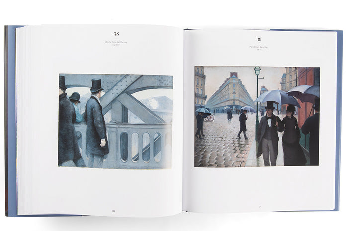 Open book showing illustrations of people with umbrellas on a rainy day.