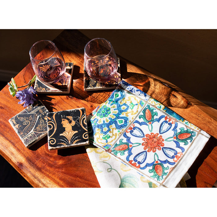 Wooden surface with wine glasses and coasters and tea towel