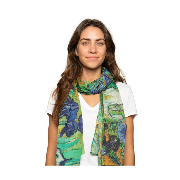 Person wearing irises scarf in a white t shirt against a white background